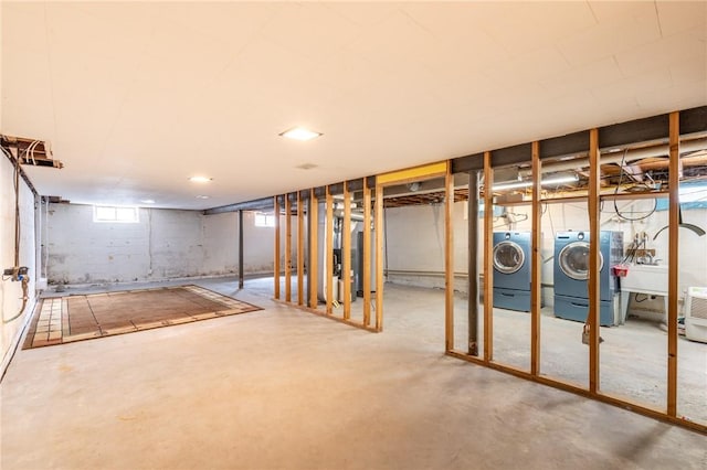 basement with independent washer and dryer and a sink