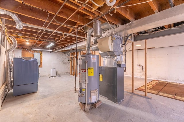 unfinished below grade area featuring water heater, washer / dryer, and heating unit