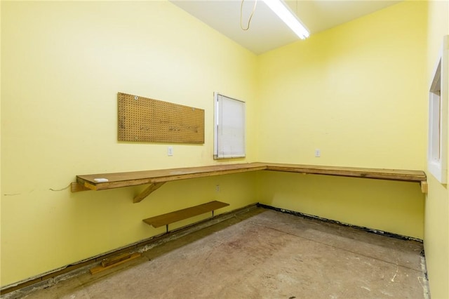 unfurnished room featuring concrete flooring