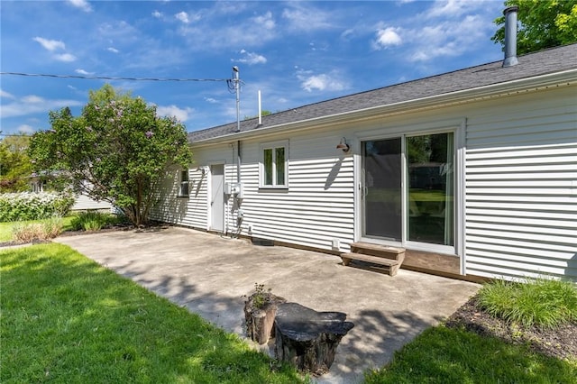 back of property featuring a patio area and a yard