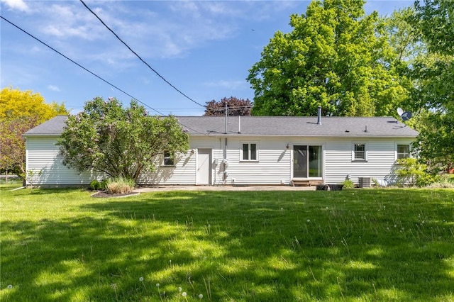 rear view of property with a lawn and entry steps