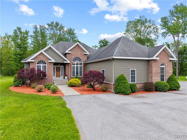 1210 Lake Rd, Oneida-Outside, NY 13421 - view of front of home with brick siding, a front lawn, and a shingled roof