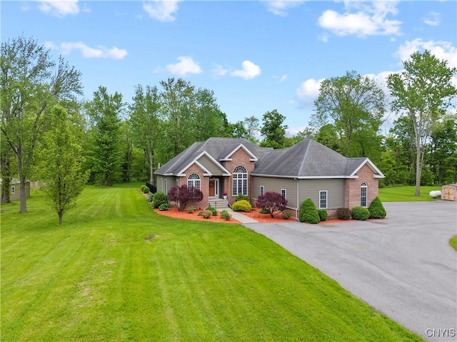 1210 Lake Rd, Oneida-Outside, NY 13421 - view of front of home featuring brick siding and a front yard