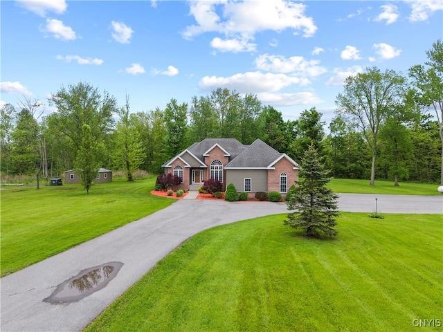 1210 Lake Rd, Oneida-Outside, NY 13421 - view of front of house with asphalt driveway, a front yard, and brick siding