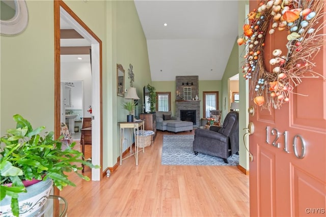 1210 Lake Rd, Oneida-Outside, NY 13421 - foyer entrance featuring light wood-type flooring, a fireplace, high vaulted ceiling, and baseboards