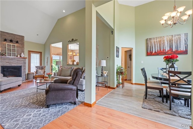1210 Lake Rd, Oneida-Outside, NY 13421 - living area featuring high vaulted ceiling, a chandelier, light wood-type flooring, baseboards, and a large fireplace
