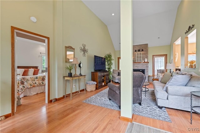 1210 Lake Rd, Oneida-Outside, NY 13421 - living area with high vaulted ceiling, plenty of natural light, wood finished floors, a fireplace, and baseboards