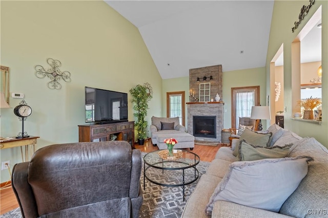 1210 Lake Rd, Oneida-Outside, NY 13421 - living room with high vaulted ceiling, wood finished floors, and a stone fireplace