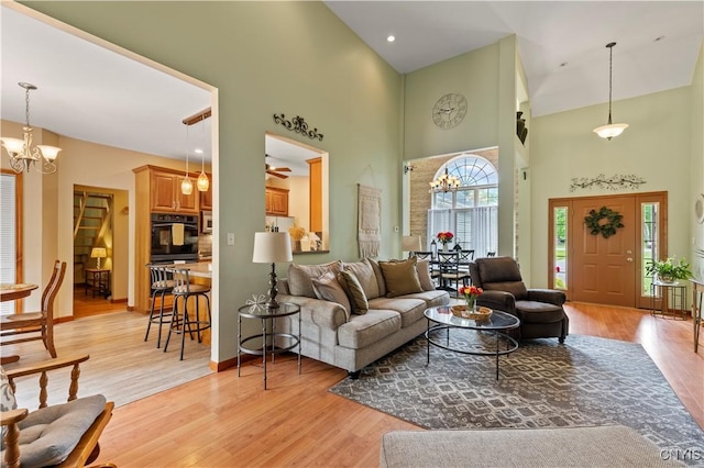 1210 Lake Rd, Oneida-Outside, NY 13421 - living area featuring a high ceiling, a chandelier, light wood-type flooring, and baseboards
