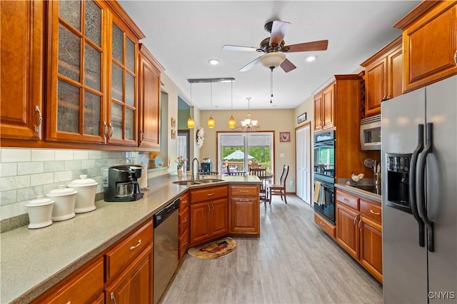 1210 Lake Rd, Oneida-Outside, NY 13421 - kitchen featuring black appliances, a sink, light wood-style flooring, brown cabinets, and a peninsula