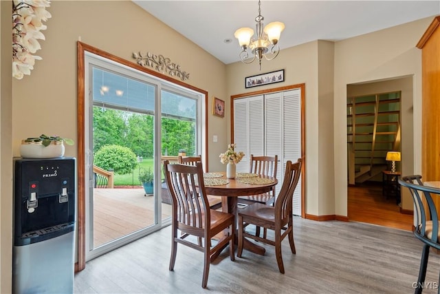 1210 Lake Rd, Oneida-Outside, NY 13421 - dining room featuring a chandelier, light wood-style floors, and baseboards