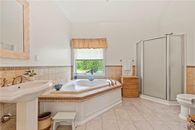 1210 Lake Rd, Oneida-Outside, NY 13421 - bathroom featuring tile walls, tile patterned flooring, a stall shower, a bath, and a wainscoted wall