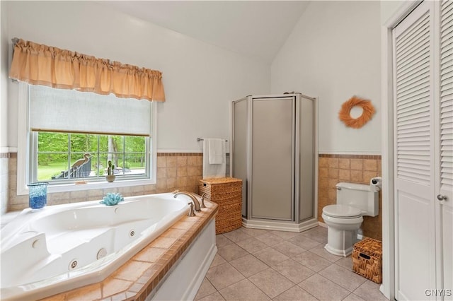 1210 Lake Rd, Oneida-Outside, NY 13421 - bathroom with tile patterned floors, a shower stall, a jetted tub, vaulted ceiling, and toilet