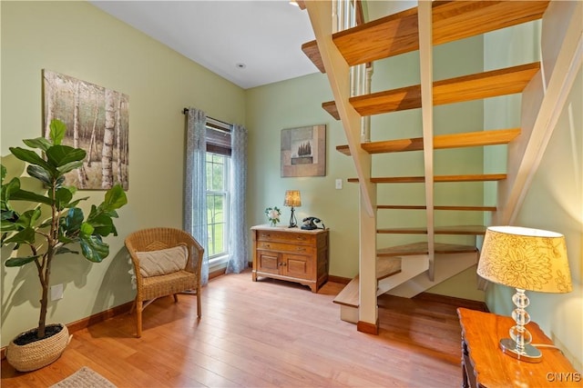 1210 Lake Rd, Oneida-Outside, NY 13421 - sitting room with wood finished floors, stairway, and baseboards
