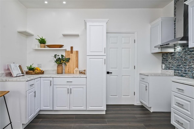 kitchen with wall chimney exhaust hood, open shelves, recessed lighting, backsplash, and dark wood-style floors
