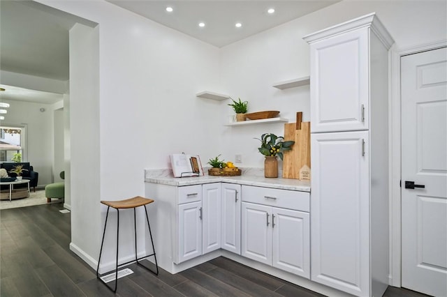 bar with dark wood-style flooring, recessed lighting, and baseboards