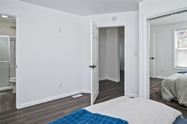 bedroom featuring dark wood-style floors and baseboards