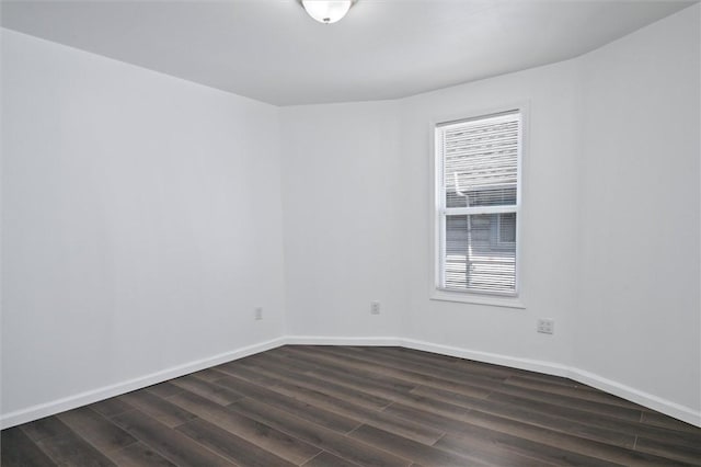 unfurnished room featuring dark wood finished floors and baseboards