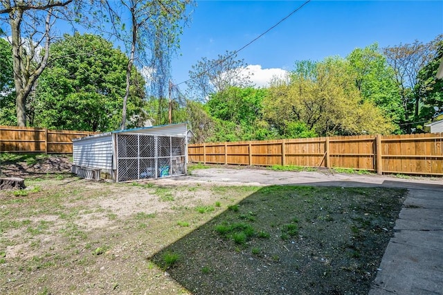fenced backyard with an outdoor structure