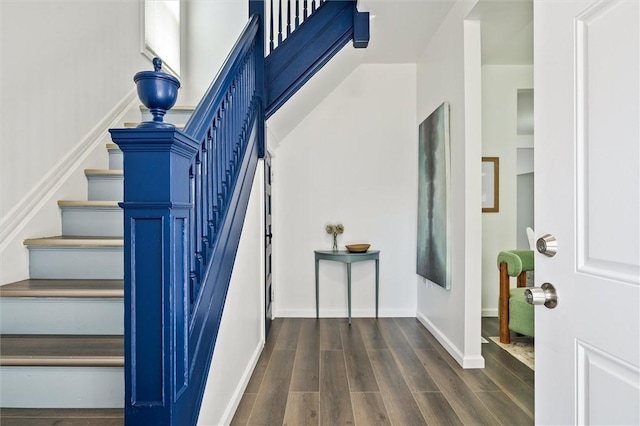 stairway featuring wood finished floors and baseboards