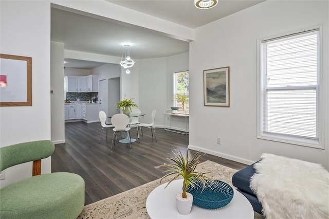 living room featuring dark wood-style flooring and baseboards