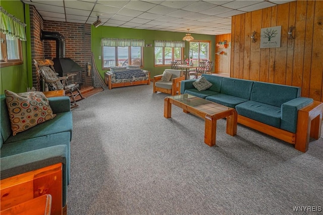 4609 E Lake Rd, Wilson, NY 14172 - carpeted living room with a wood stove, a drop ceiling, and wooden walls