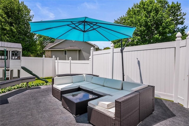 fenced backyard with an outdoor living space and a patio