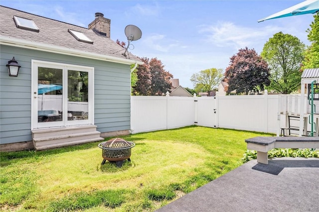 view of yard featuring an outdoor fire pit and a patio area