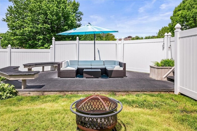 view of yard with an outdoor living space with a fire pit and a patio