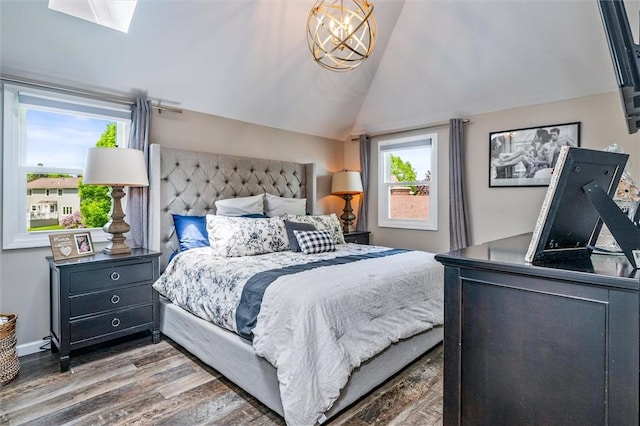 bedroom featuring wood finished floors and lofted ceiling