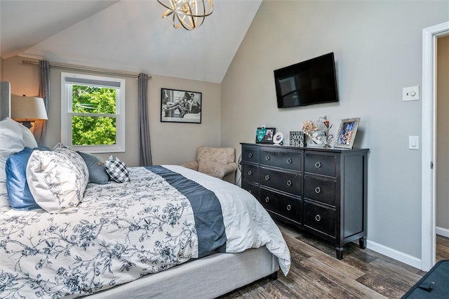 bedroom with dark wood-type flooring, vaulted ceiling, baseboards, and a chandelier