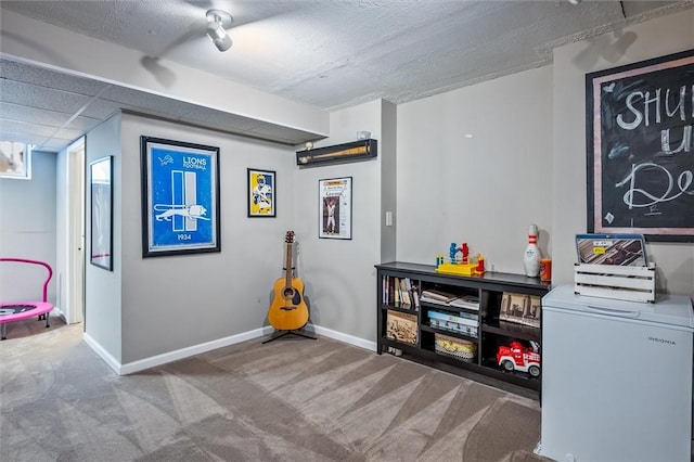 misc room with baseboards and carpet flooring