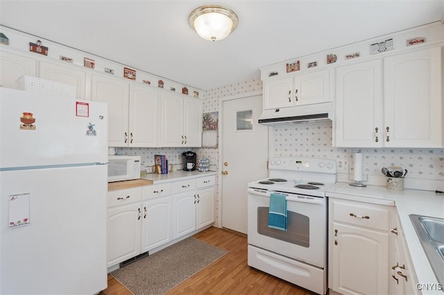 104 Hillside, Camillus, NY 13031 - kitchen with white appliances, under cabinet range hood, backsplash, and white cabinetry