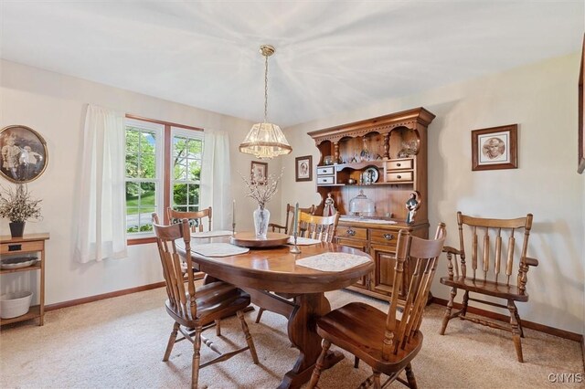 104 Hillside, Camillus, NY 13031 - dining space featuring a chandelier, light carpet, and baseboards