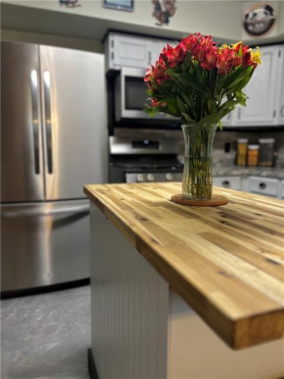 4600 College Ave, Corning, NY 14830 - kitchen with freestanding refrigerator, wooden counters, white cabinets, and white microwave