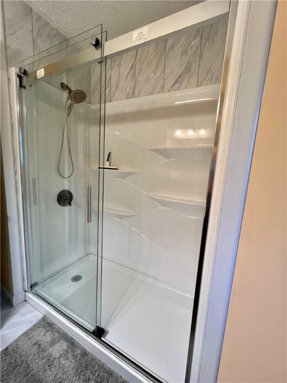 4600 College Ave, Corning, NY 14830 - bathroom with a stall shower and a textured ceiling