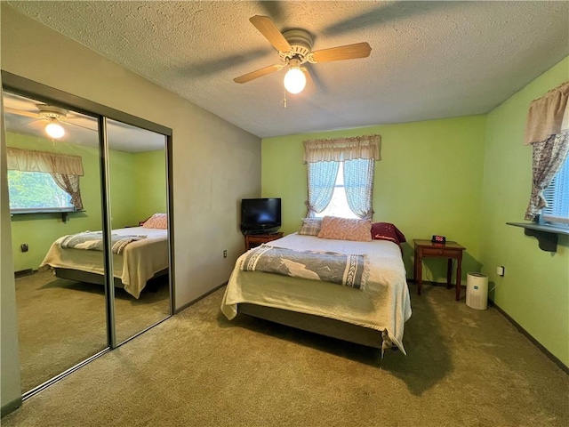 4600 College Ave, Corning, NY 14830 - carpeted bedroom with multiple windows, a closet, a textured ceiling, and ceiling fan