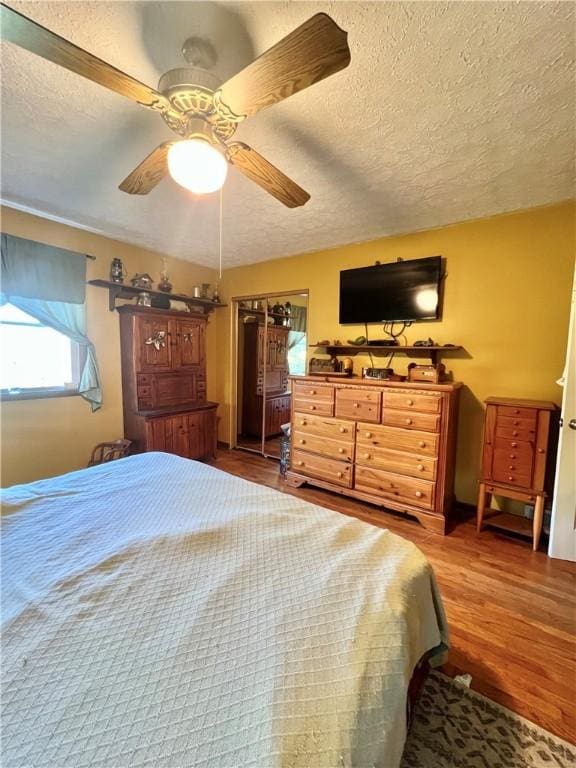 4600 College Ave, Corning, NY 14830 - bedroom with a textured ceiling, wood finished floors, and ceiling fan