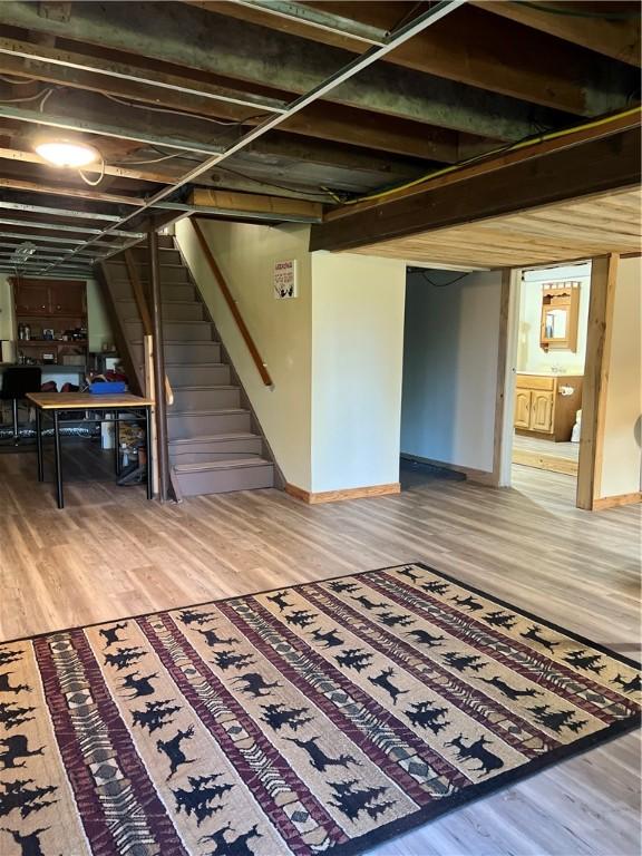 4600 College Ave, Corning, NY 14830 - finished basement with stairway, light wood-style flooring, and baseboards