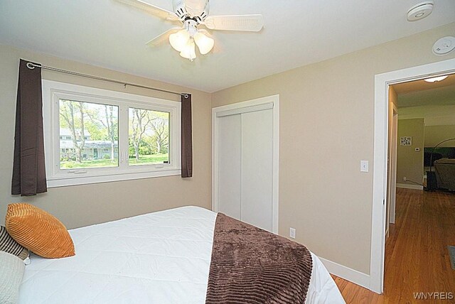 458 Kenwood Dr, Lewiston, NY 14092 - bedroom with wood finished floors, a closet, ceiling fan, and baseboards