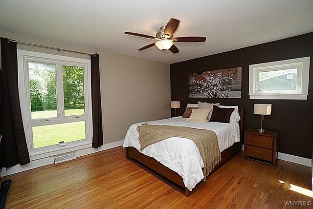 458 Kenwood Dr, Lewiston, NY 14092 - bedroom with wood finished floors, baseboards, and ceiling fan
