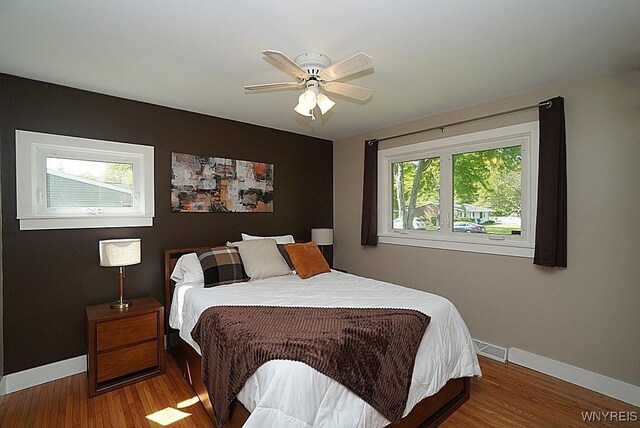 458 Kenwood Dr, Lewiston, NY 14092 - bedroom featuring baseboards, wood finished floors, and ceiling fan