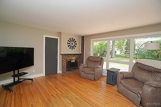 458 Kenwood Dr, Lewiston, NY 14092 - living area featuring light wood finished floors, a fireplace, and baseboards