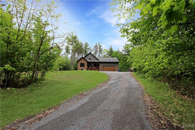 7030 Peckham Rd, Watson, NY 13367 - view of front of house with asphalt driveway, an attached garage, brick siding, and a front yard