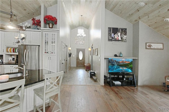 7030 Peckham Rd, Watson, NY 13367 - kitchen with stainless steel refrigerator, high vaulted ceiling, wood ceiling, a sink, and a kitchen breakfast bar