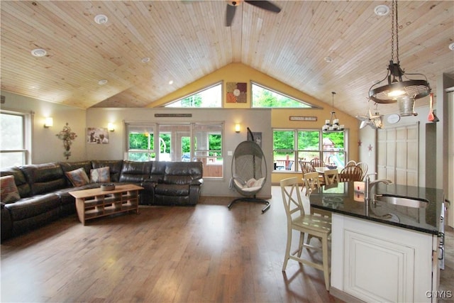 7030 Peckham Rd, Watson, NY 13367 - living area featuring ceiling fan, wood-type flooring, vaulted ceiling, and a chandelier