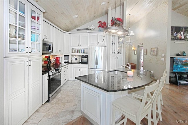 7030 Peckham Rd, Watson, NY 13367 - kitchen with stainless steel appliances, vaulted ceiling, a sink, wood ceiling, and glass insert cabinets