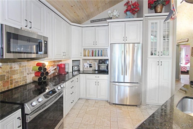7030 Peckham Rd, Watson, NY 13367 - kitchen with stainless steel appliances, vaulted ceiling, wooden ceiling, decorative backsplash, and white cabinets