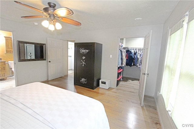 7030 Peckham Rd, Watson, NY 13367 - bedroom with light wood finished floors, a spacious closet, a closet, and a ceiling fan