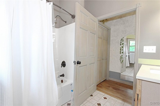 7030 Peckham Rd, Watson, NY 13367 - full bath with shower / bath combo with shower curtain, vanity, wood finished floors, and baseboards